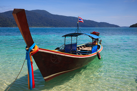 长尾船坐在海滩上拉威岛泰国图片