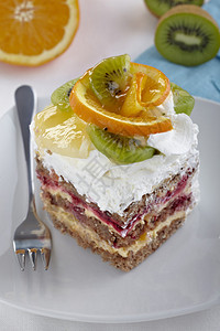 白色盘子上的水果奶油蛋糕特写图片