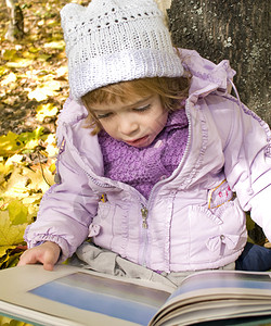 女孩在秋天的公园里看书图片