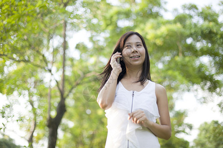 在公园里讲妇女手机的交流主题图片