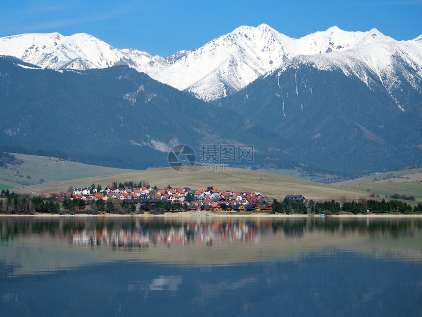 名为LiptovskyTrnovec的小村庄位于Rohace山脉巨大的雪山下图片