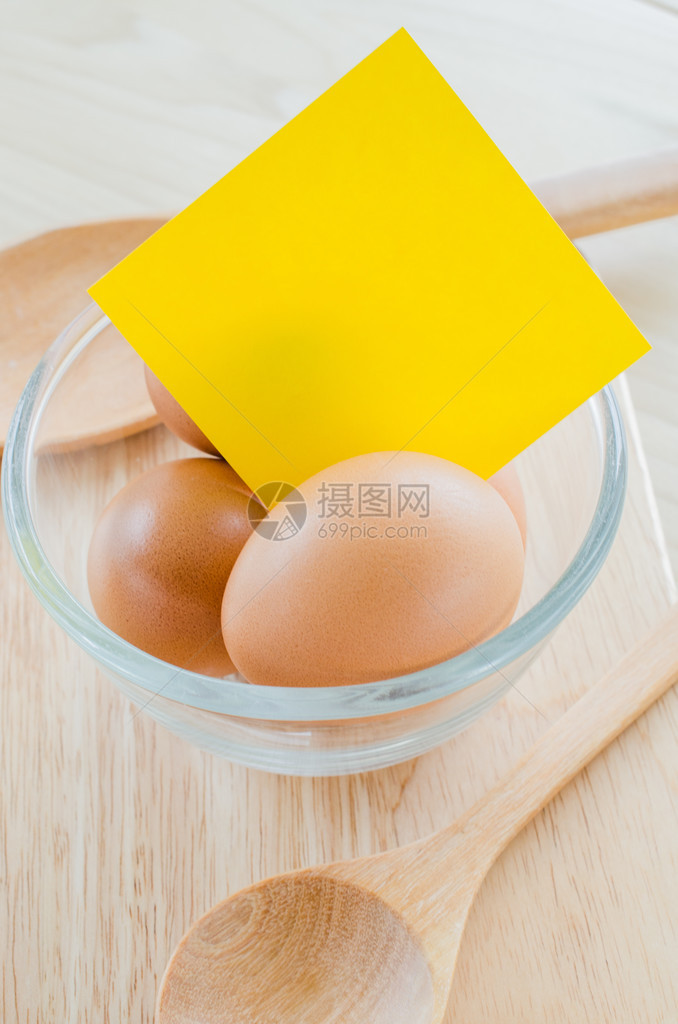 木桌上的鸡蛋带有黄色音符图片