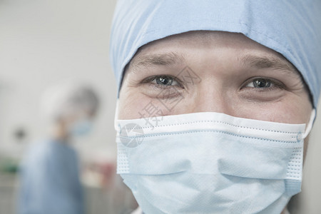 在手术室戴外科面具和外科帽的图片