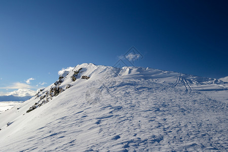 雪地斜坡由风形成山图片