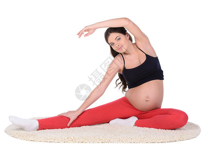 一名孕妇在白种背景上进图片