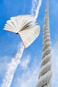 飞翔的书和绳子高升至蓝图片