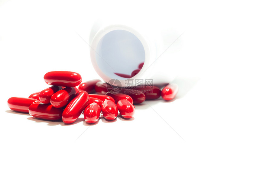 红色药丸和药瓶在白色图片