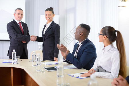 商务会议商务会议穿着正装的商务人士坐在桌旁图片