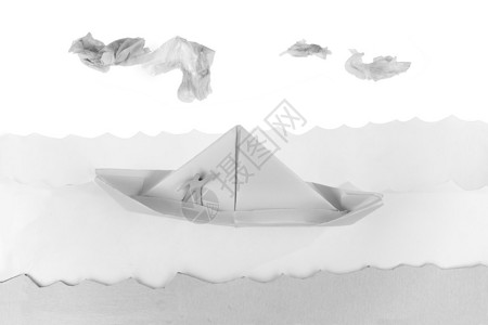 漂浮在白皮书海洋中的纸船背景图片