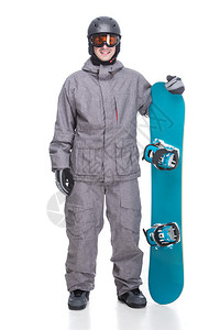 穿着冬衣的帅哥拿着一块蓝色滑雪板图片