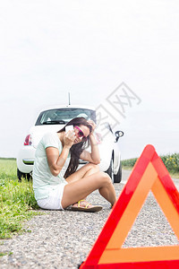 在农村公路上乘车撞坏时使用手机的女图片