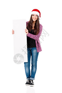 戴着圣诞老人帽子的快乐微笑女孩展示空白招牌图片