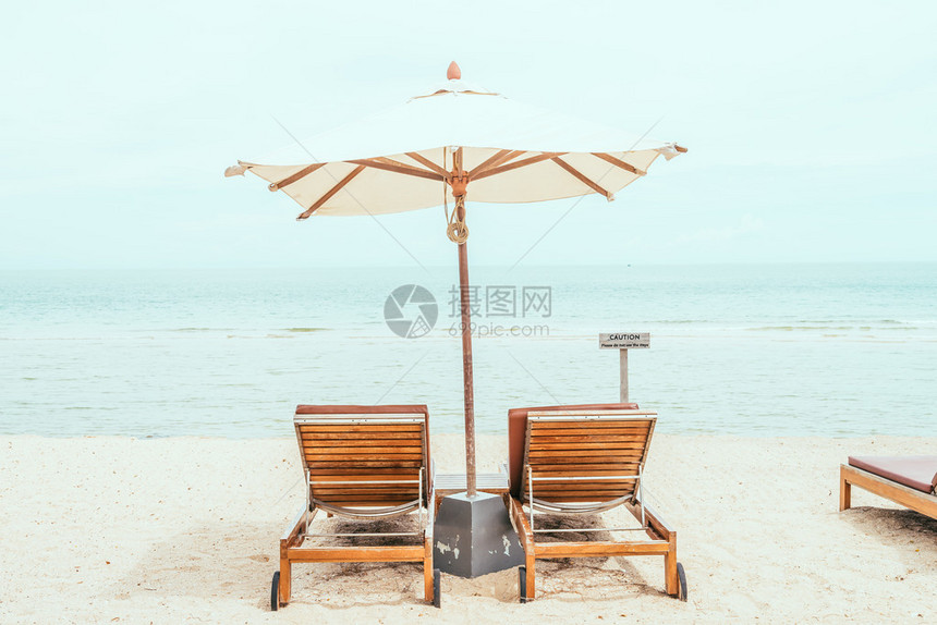 带热海洋和海滩的雨伞和椅子图片