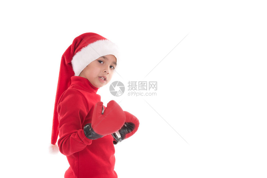 穿着红毛衣和帽子的男孩穿上新年礼物图片