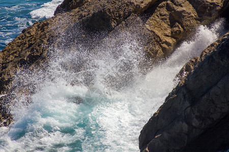 海浪拍打着白色泡沫的岩石图片