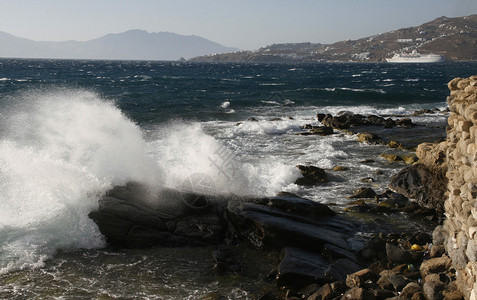 海浪拍打在石滩上形成浪花图片