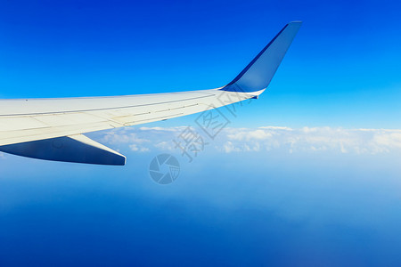 云上蓝天背景下的飞机翼图片