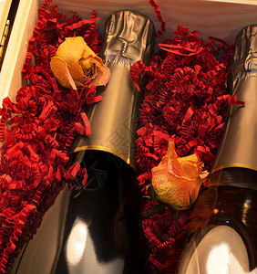 黄色玫瑰和大瓶香槟在装满红面图片