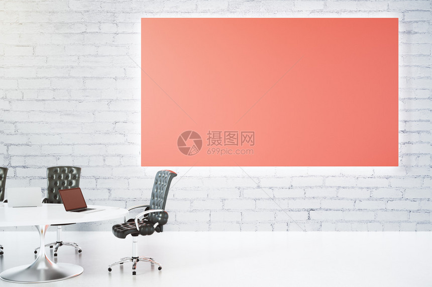 白砖墙上的空白大红色海报和带皮椅和笔记本电脑图片