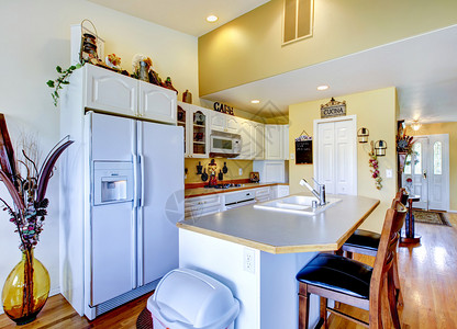 厨房内部配有白色电器和硬木地板图片