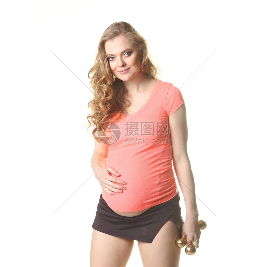 孕妇与哑铃一起锻炼运动怀孕妇女与培训图片