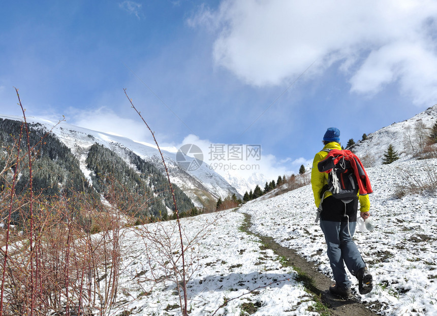 背着包走在山间小径的徒步旅行者图片