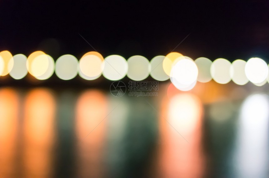 夜间水中灯光的模糊反射抽象背景图片