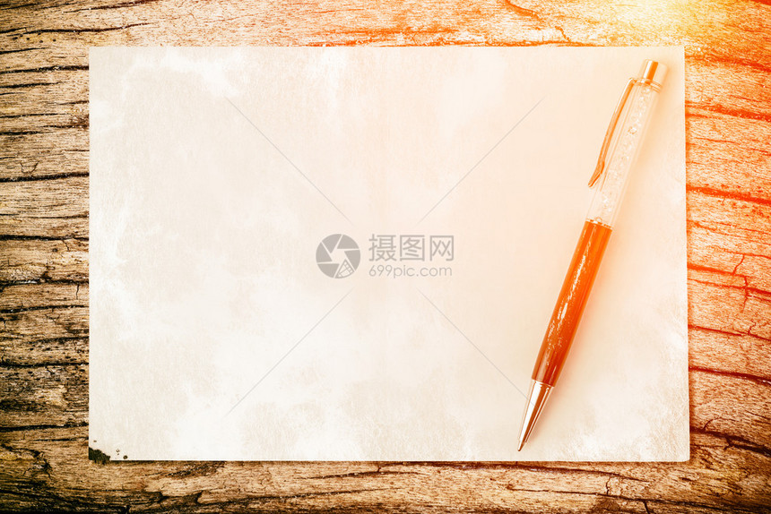 笔在纸质背景上带有光和耀斑经营理念图片