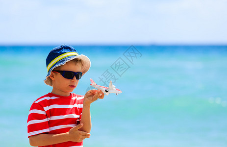 小男孩在海滩玩具飞机图片