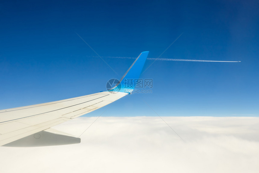 蓝天背景的云上方飞行的图片
