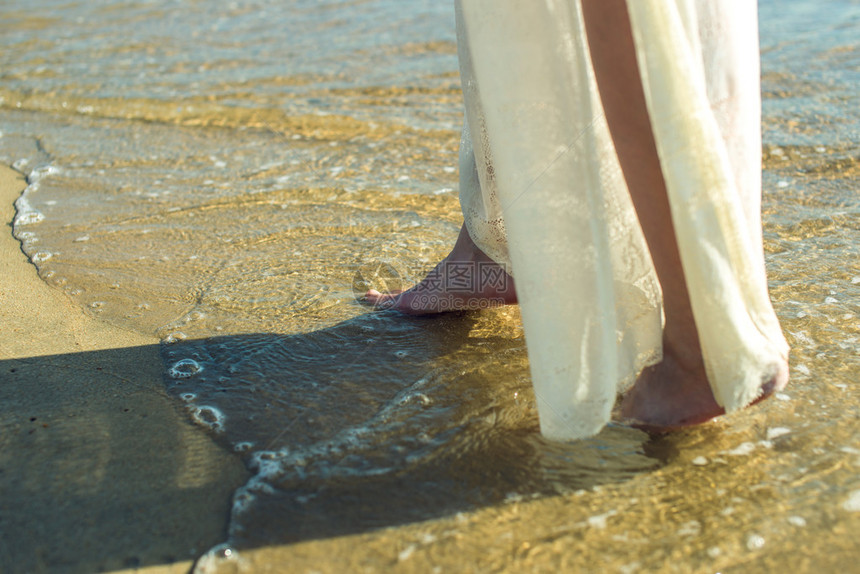 女孩赤脚在海滩上的沙滩图片