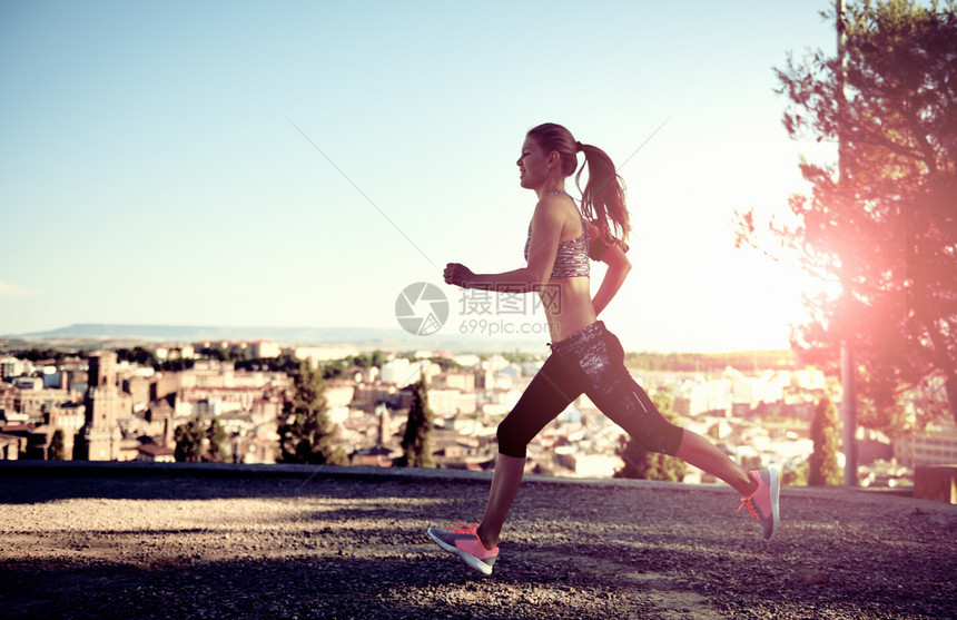 跑步的女在日落户外运动图片