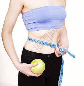 以白色背景孤立的带子衡量胃部的女童有皮肤的妇女饮食保健人员概念接图片