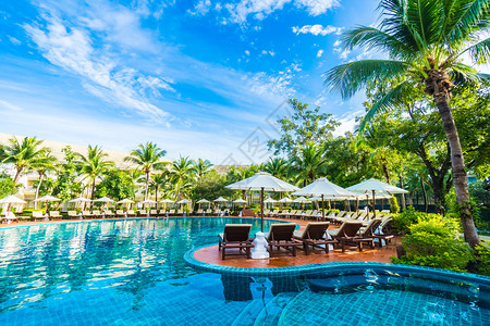 酒店和度假村室外游泳池周围美丽的豪华伞和椅子图片