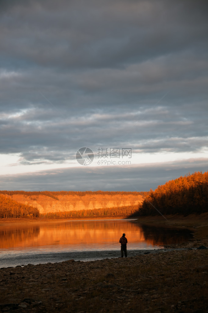 晚上在西伯利亚河秋天钓鱼日落时河上的渔夫在晚上鄂温克河图片