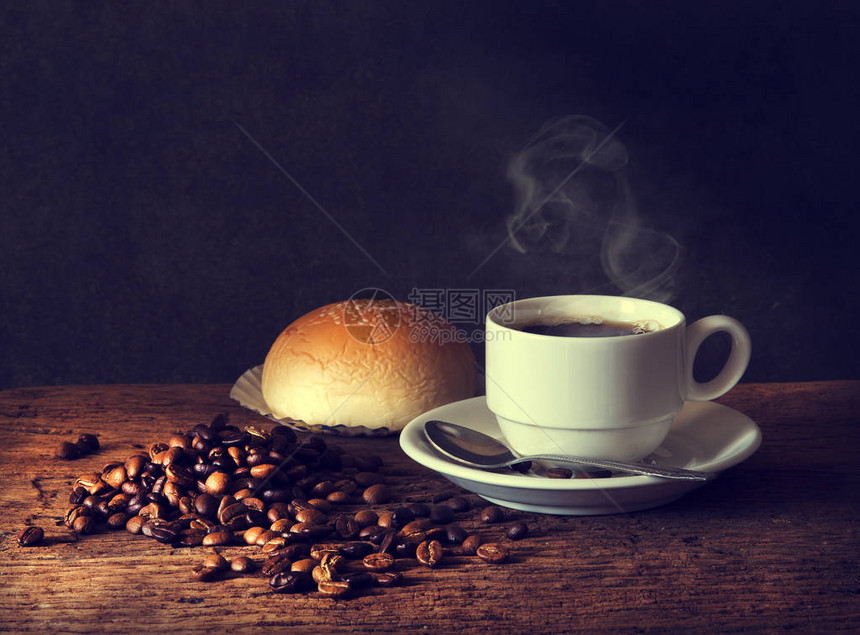 咖啡杯和咖啡豆的热咖啡木制桌图片