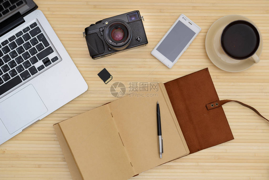 复古时髦木顶桌笔记本电脑和一杯咖啡相机皮革笔记本电话图片