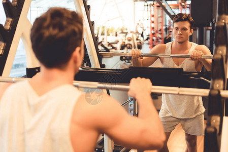 年轻有魅力的肌肉男在健身房锻图片