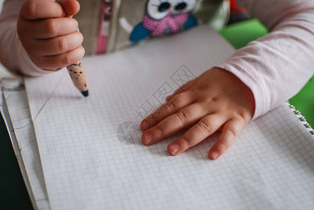 儿童用蜡笔在纸上画图片