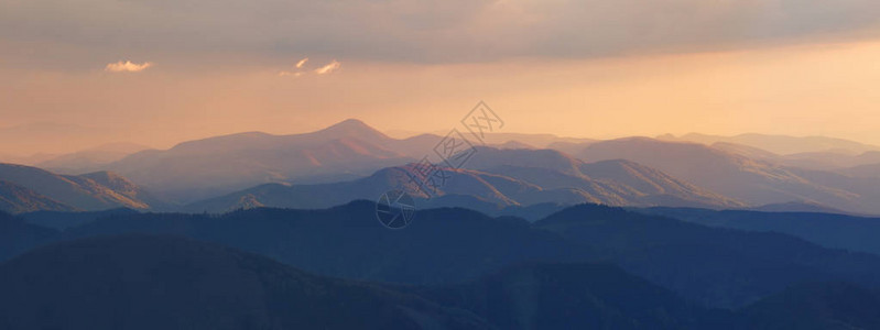 的傍晚阳光照在山顶上朦胧的晚上景观夏季全景背在山的美图片