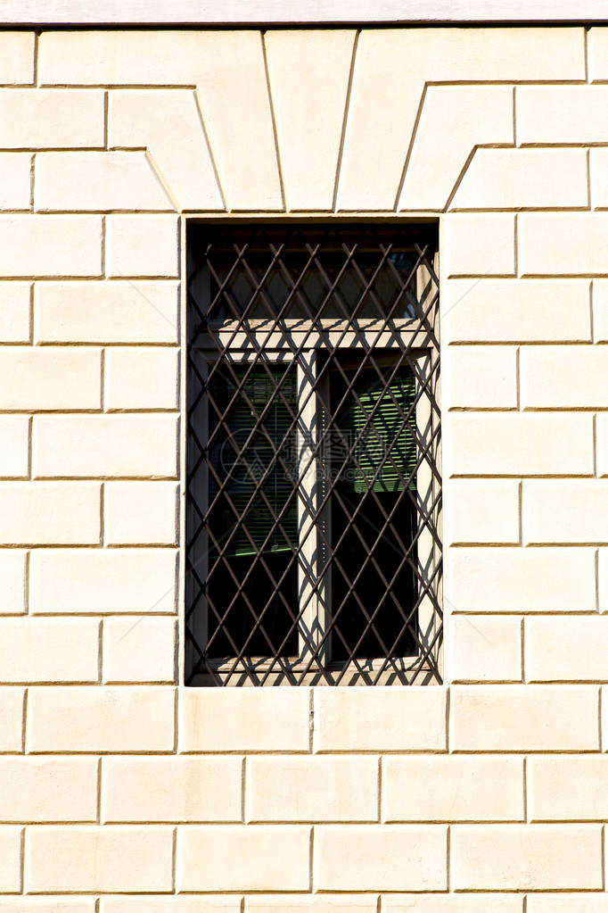 在米拉诺旧窗户里关闭的砖块抽象格子上长着图片
