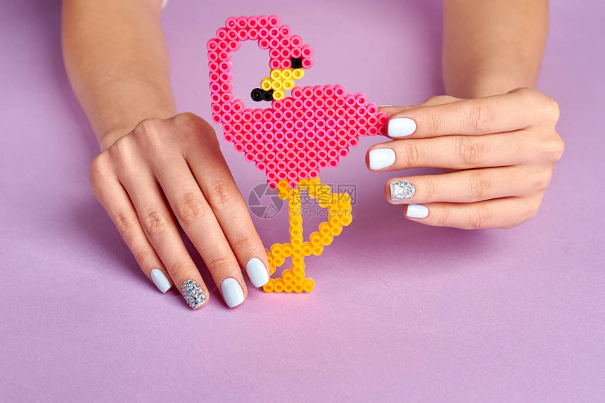 明亮的玩具粉红色火烈鸟儿童玩具手工艺品图在妇女手中图片