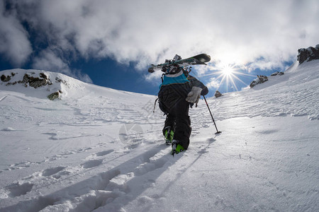 滑雪自由骑手在深雪中攀登斜坡粉末图片