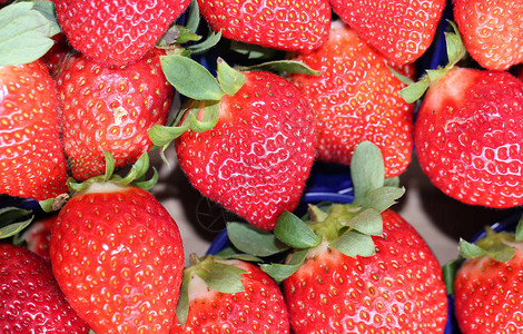 在蔬菜水果店出售的成熟红草莓的背景图片