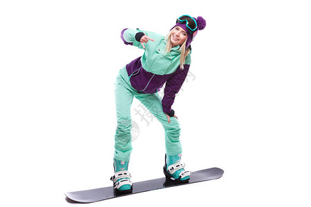 穿着紫色滑雪服蓝裤子和雪眼镜的白漂亮的caucasians女人骑着图片