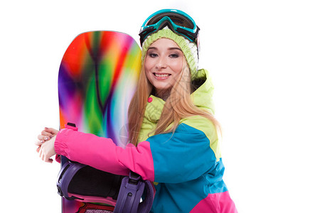 身穿彩色滑雪服和蓝色滑雪眼镜的白人迷人的年轻白人女孩与世隔绝图片