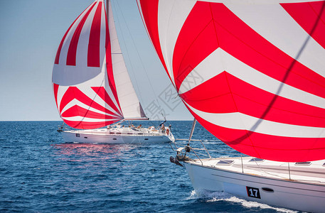 两个帆船与三角帆在海上赛事期间背景图片