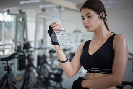 运动型女人亚洲在健身房锻炼后喝水健身图片