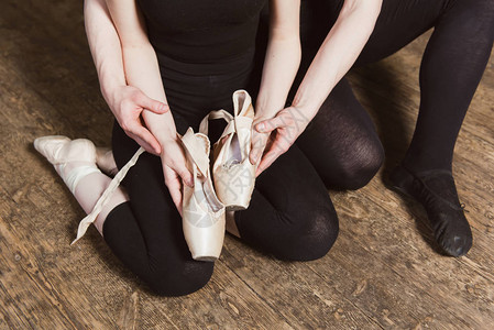 Ballerina和男芭蕾舞者手握着芭蕾舞鞋图片