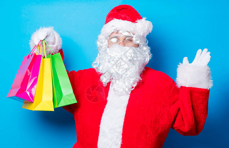 有趣的圣诞老人有一个乐趣与购物袋图片